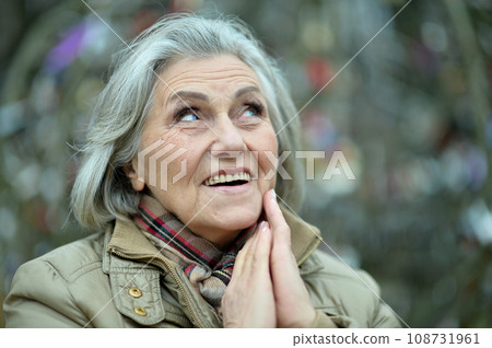 Senior woman walking in the park in autumn.  108731961