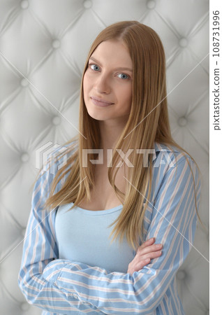 Beauty portrait. Young woman on grey wall background. 108731996