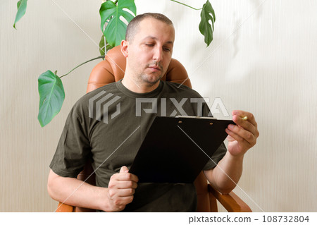 A man suffers from depression and sits alone at home. Post-traumatic stress disorder concept 108732804