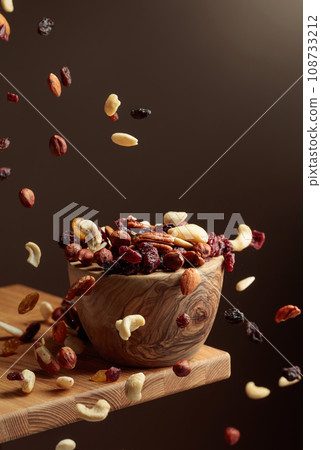 Flying dried fruits and nuts. 108733212