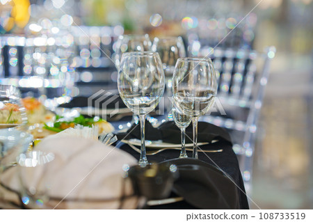 Empty wine glasses on a table with a black tablecloth. Empty wine glasses on a table with a black tablecloth. 108733519