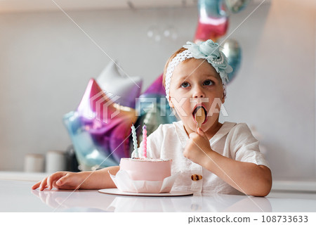 Child celebrating her three years anniversary Child celebrating her three years anniversary 108733633