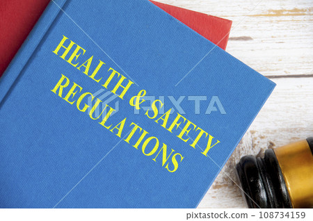 Top view of Health and Safety Regulations on blue book with gavel background. Law concept 108734159