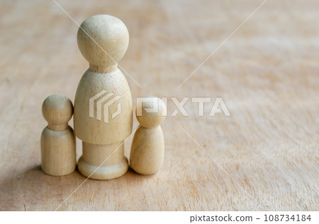 Wooden figure represent a mother with two children. Family concept Wooden figure represent a mother with two children. Family concept 108734184