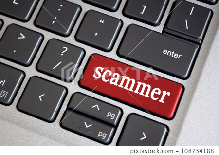 Scammer text on red color keyboard. Security and cyber attach concept 108734188