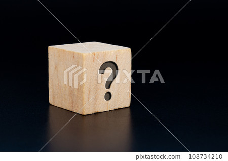 Question mark engraved on wooden cube with dark background. Question and Answer session. 108734210