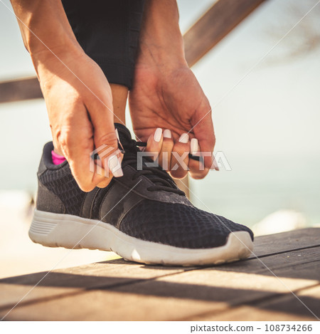 feet running on road closeup on shoe 108734266