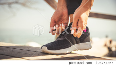 feet running on road closeup on shoe 108734267