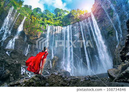 Young woman standing at Air Tumpak Sewu Waterfall, Indonesia. 108734846