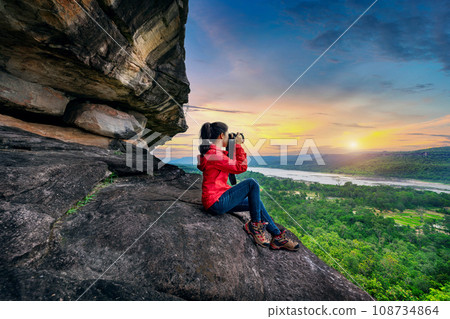 Tourist taking a photo at Pha taem national park in Ubon ratchathani, Thailand. 108734864