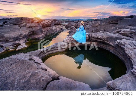 Tourist sitting at Sam Phan Bok in Ubon ratchathani, Thailand. Grand canyon of Thailand. 108734865