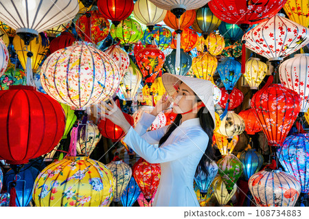 Asian woman wearing vietnam culture traditional and hoi an lanterns at Hoi An ancient town, Vietnam. Asian woman wearing vietnam culture traditional and hoi an lanterns at Hoi An ancient town, Vietnam. 108734883