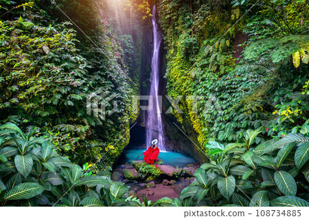 Tourist standing at Leke Leke waterfall in Bali, Indonesia. 108734885