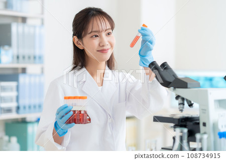 Young female researcher doing experiments in the laboratory Young female researcher doing experiments in the laboratory 108734915