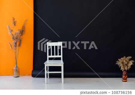 white chair on black background decorative flowers interior in the room 108736156