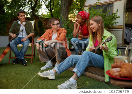 Summer party camping of diverse friends group with guitar music Summer party camping of diverse friends group with guitar music 108736779