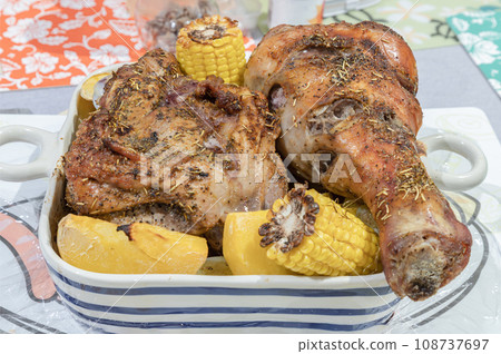 Delicious roasted turkey garnished with rosemary served with Potatoes and Corn. 108737697