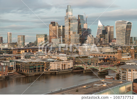 Evening time scene with bright glowing lights of various skyscrapers at London city. 108737752