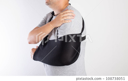 A man's arm in a black bandage for immobilization of the elbow joint after an injury. Bandage for rehabilitation after fractures of the humerus, ulna and radius. Sprain, traumatology A man's arm in a black bandage for immobilization of the elbow joint after an injury. Bandage for rehabilitation after fractures of the humerus, ulna and radius. Sprain, traumatology 108738051
