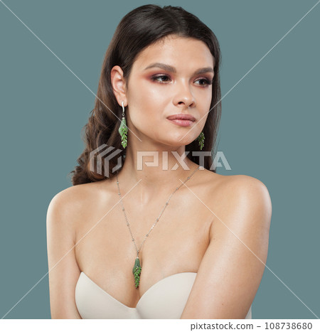 Nice brunette woman with shiny clear skin wearing jewelry golden necklace and long earring 108738680