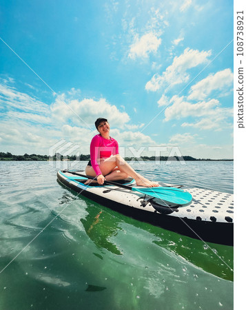 beautiful woman sitting down on the supboard beautiful woman sitting down on the supboard 108738921