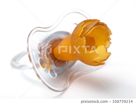 A chewed silicone pacifier on a white background, close-up. Poor quality pacifier, sucking reflex in children, orthodontic A chewed silicone pacifier on a white background, close-up. Poor quality pacifier, sucking reflex in children, orthodontic 108739214