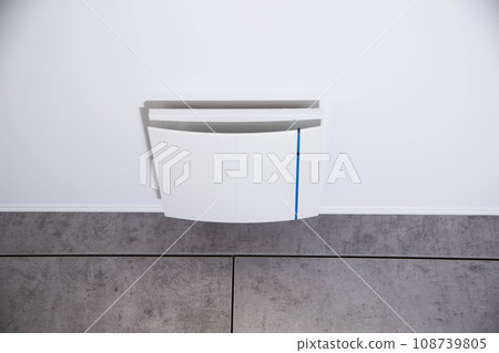 Modern exhaust ventilation in the bathroom with a non-return valve and a stretch ceiling. Humidity in the room. Close-up Modern exhaust ventilation in the bathroom with a non-return valve and a stretch ceiling. Humidity in the room. Close-up 108739805