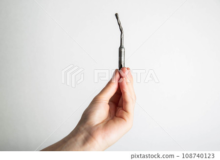 Poor quality broken metal drill on a white background, close-up 108740123