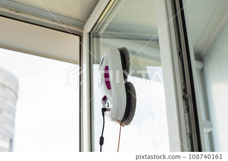 A modern device, a robot window cleaner for cleaning glass from dirt and streaks. A modern device, a robot window cleaner for cleaning glass from dirt and streaks. 108740161