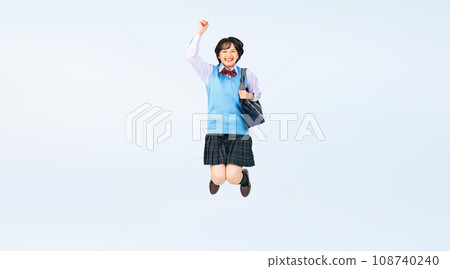 Female student in uniform jumping, cropped full body photo 108740240