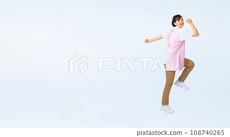 Woman wearing an apron jumping, childcare worker, care worker, cropped full-body photo Woman wearing an apron jumping, childcare worker, care worker, cropped full-body photo 108740265