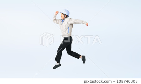Cropped full-body photo of a female worker engineer wearing a jumping helmet and work clothes 108740305
