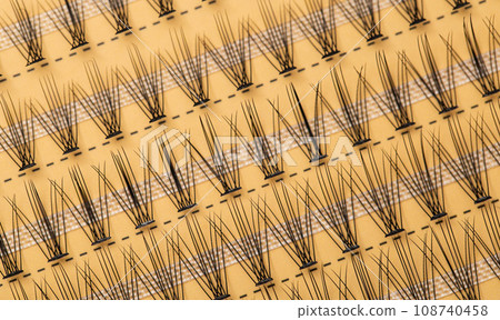 Modern set of false eyelashes for gluing. Women's cosmetics, close-up Modern set of false eyelashes for gluing. Women's cosmetics, close-up 108740458