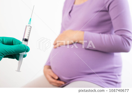 the doctor holds a syringe with the drug anti-rhesus immunoglobulin for the prevention of rhesus conflict in rhesus-negative women. 108740677