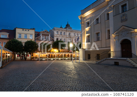 beautiful street restaurants with illuminated and flowers on the market in Leszno at dusk. Poland 108741120