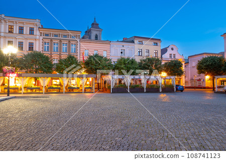 beautiful street restaurants with illuminated and flowers on the market in Leszno at dusk. Poland 108741123
