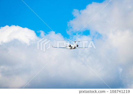 flown away airplane against a blue sky with beautiful white clouds 108741219