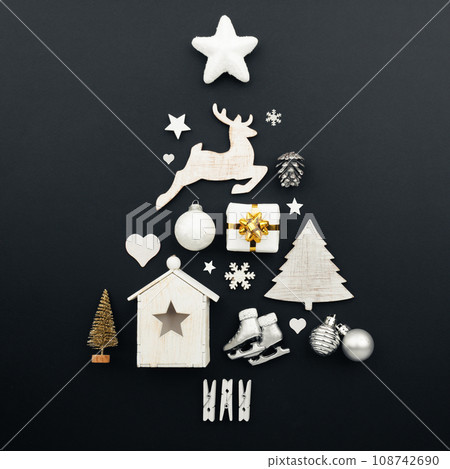 Christmas tree made of decorations on black background Christmas tree made of decorations on black background 108742690