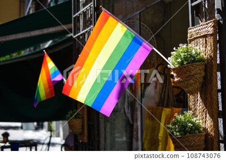 Waving LGBT flags on the building in Madrid city 108743076