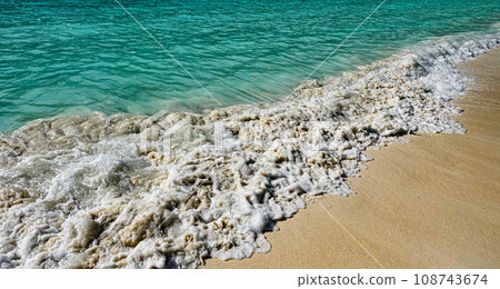 Sea waves on the sandy beach of Maya Bay. Phi Phi Island in Thailand. Sea waves on the sandy beach of Maya Bay. Phi Phi Island in Thailand. 108743674