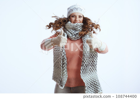 stylish woman on white showing thumbs up and jumping stylish woman on white showing thumbs up and jumping 108744400
