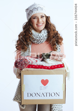 smiling woman in sweater, mittens, hat and scarf on smiling woman in sweater, mittens, hat and scarf on 108744404