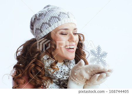 smiling 40 years old woman in sweater, mittens, hat and scarf 108744405