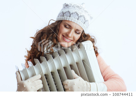 relaxed female in sweater, mittens, hat and scarf on relaxed female in sweater, mittens, hat and scarf on 108744411