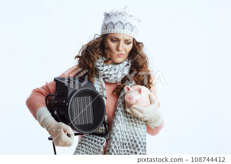 stylish female in sweater, mittens, hat and scarf on white stylish female in sweater, mittens, hat and scarf on white 108744412