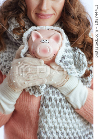 Stylish woman in sweater, mittens, hat and scarf on Stylish woman in sweater, mittens, hat and scarf on 108744413