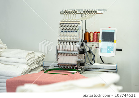Close up of embroidery machine making patterns on textiles 108744521