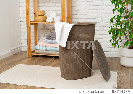 Pile of clothes in plastic laundry basket in the bathroom 108744929
