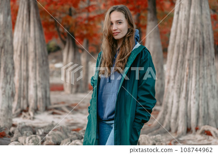 Young attractive woman walking down the park. Beautiful lady looking at the camera. 108744962