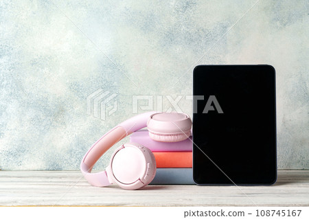 Stack of books and digital tablet on wooden desk Stack of books and digital tablet on wooden desk 108745167